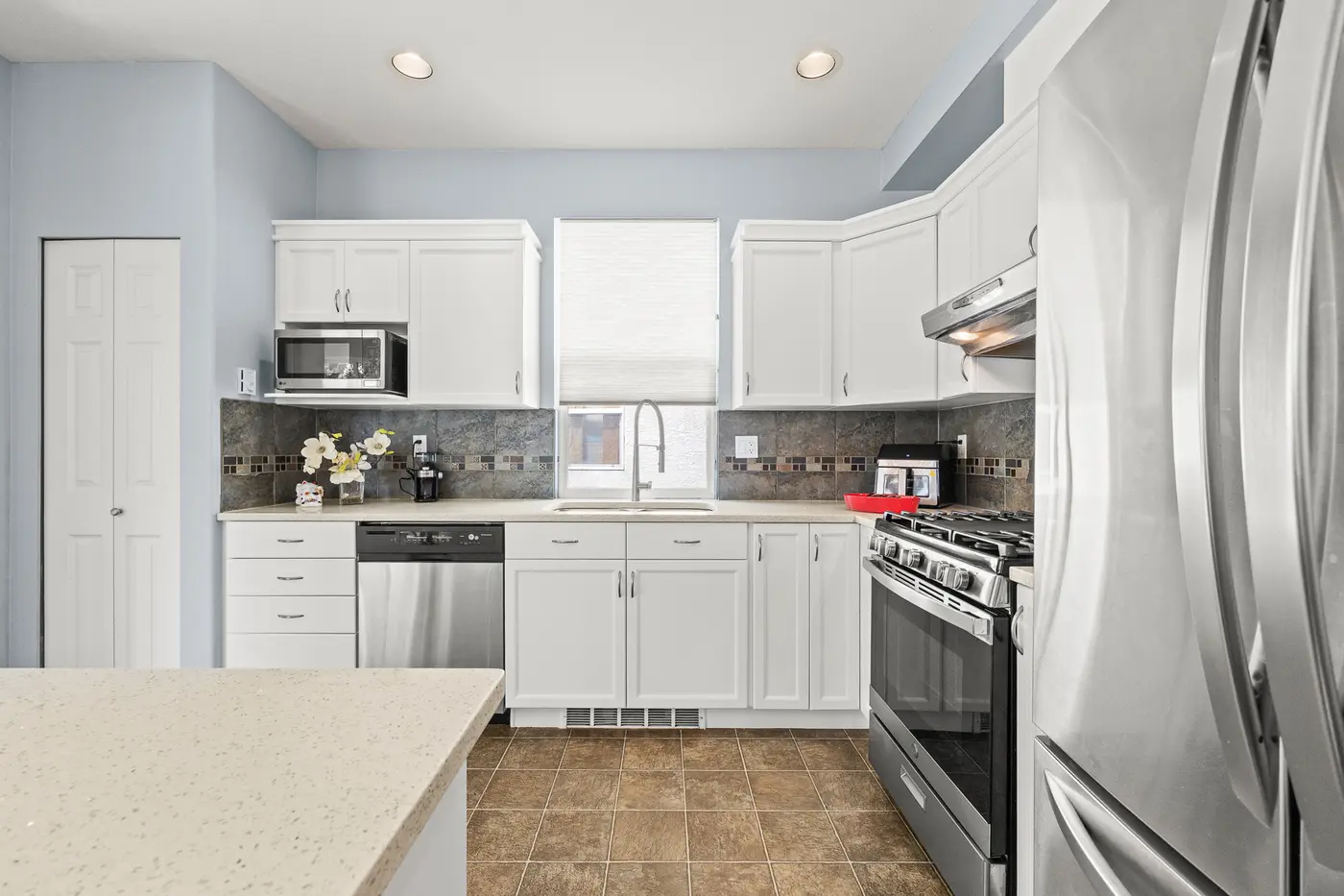 Kitchen with stainless appliances and gas range, 3307 Rosemary Heights Crescent